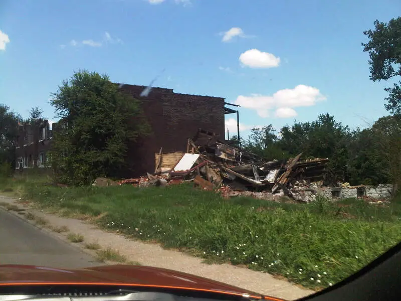 Severely Damaged Apartment Building And Debris