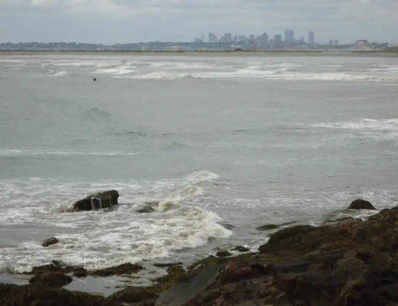 Lynn Massachusetts Surfers Riding Waves With Boston In Background