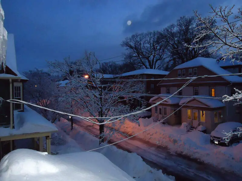 Summit New Jersey Street After Snowfall In Early Morning With Houses And Porches And Car And Moon
