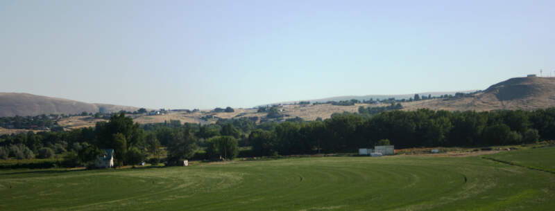 West Richland  As Seen Across Yakima River  Flat Top Hill To Right  Houses In Highlands Behind  July